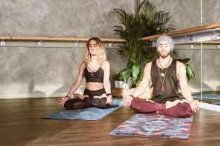 man and woman doing yoga